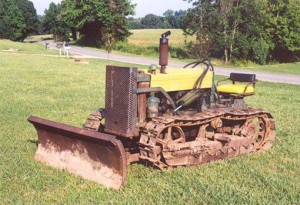 Hattie's nephew writes that "cat" was and still is the common name for a track type tractor, first were made by Caterpillar. The winter of 1951-52 brought heavy snow so Will Whitcher bought a "cat." The picture is of a slightly newer model.